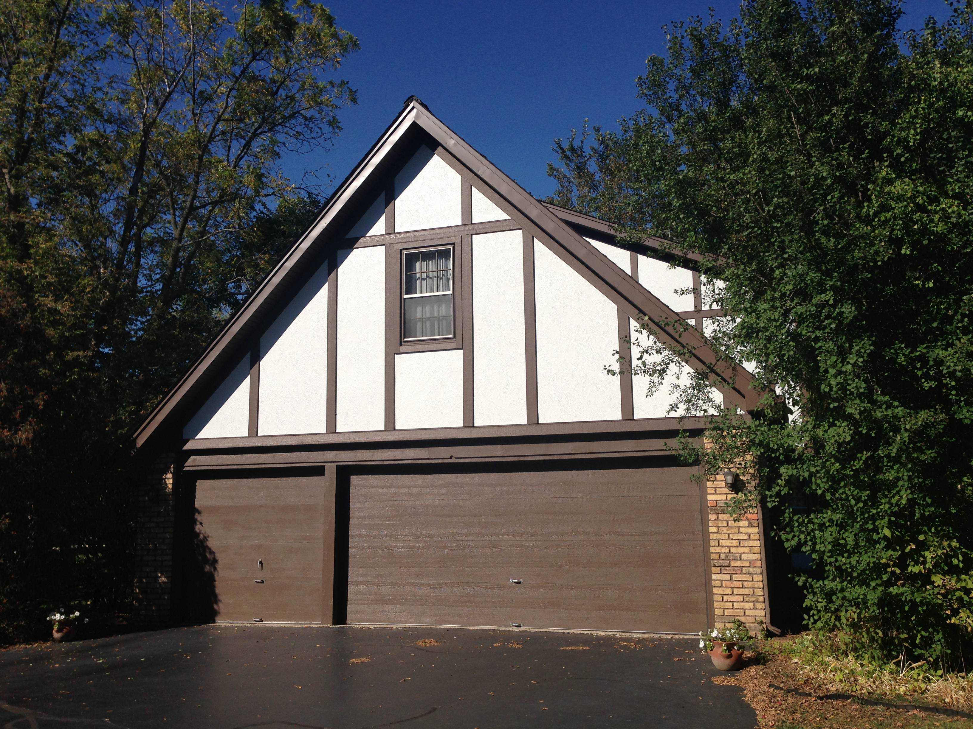 Stucco Hardie Arctic White Panels with London Brown Hardie Trim on Tudor Home in St Charles