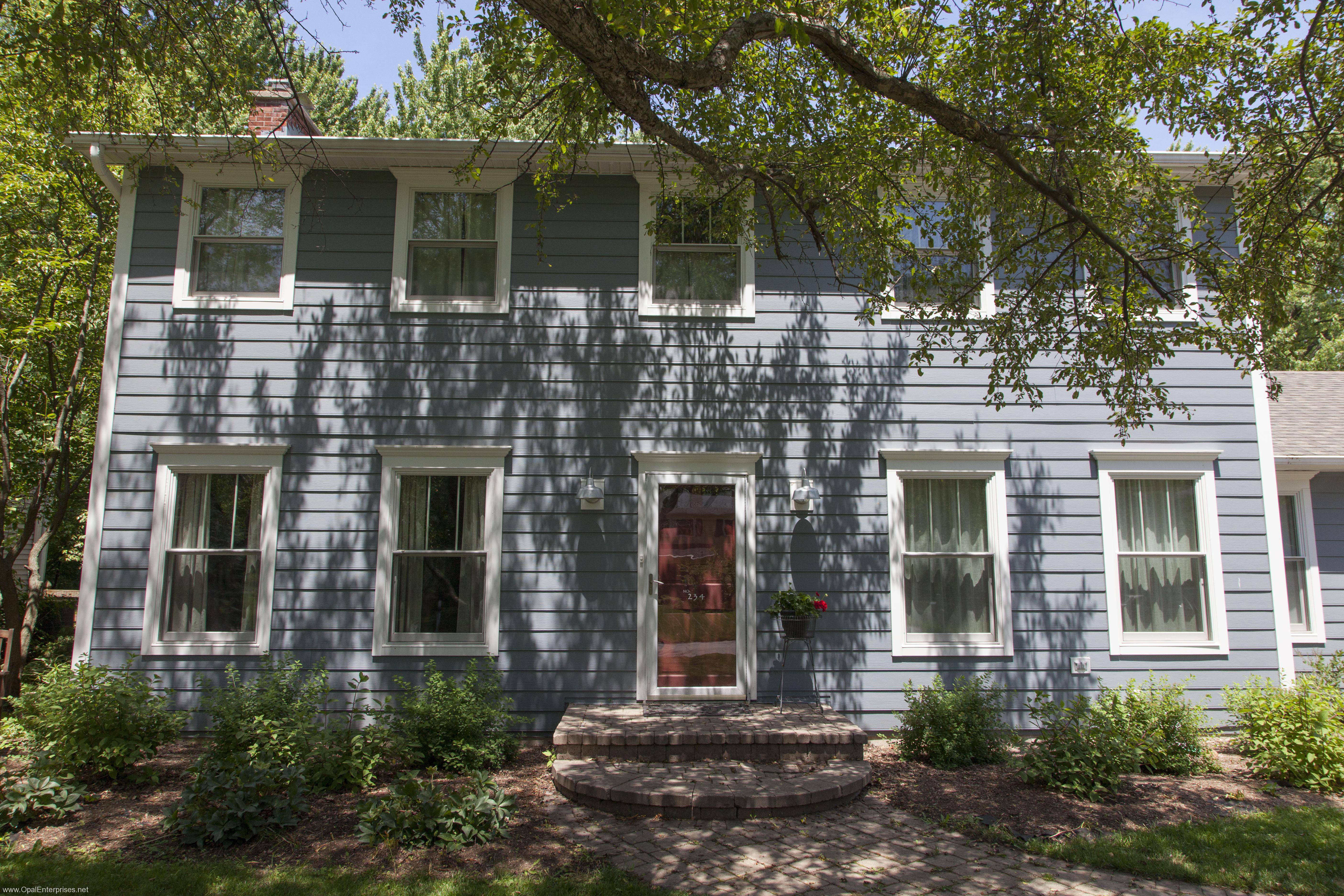 Newly renovated home with James Hardie Siding, red door, and white trim in Wheaton #OpalCurbAppeal