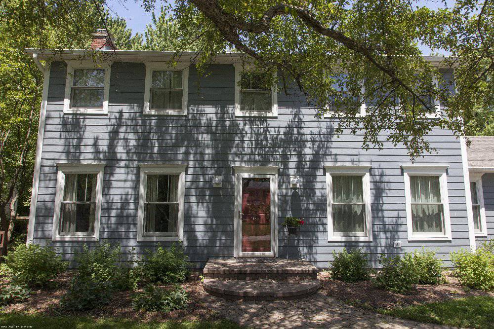 light blue home with white trim and red door