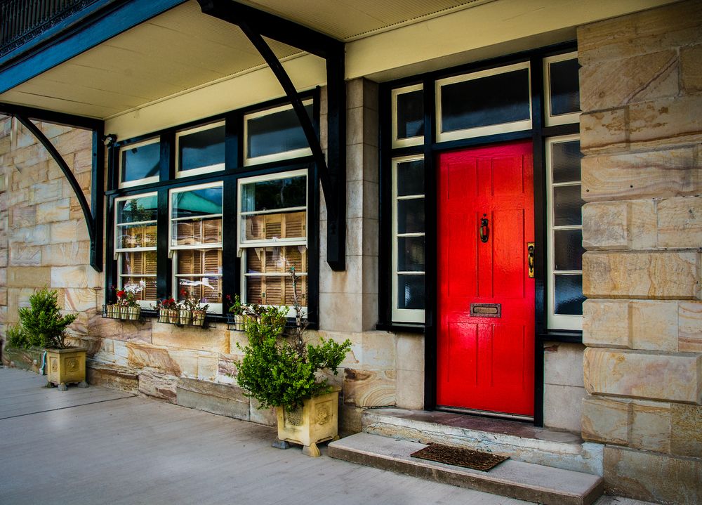 red front door flanked by black trim