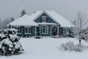 A country home surrounded by snow.