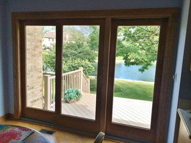 Beautiful inside and out! This gliding door features custom stained wood clad interior framing.
