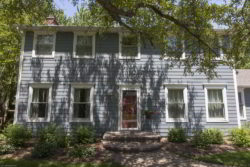 Newly renovated home with James Hardie Siding, red door, and white trim in Wheaton Illinois.