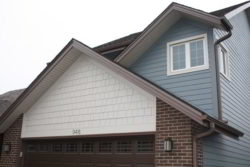 Westmont home featuring James Hardie Boothbay Blue lap siding and Arctic White Hardie shake above the garage.