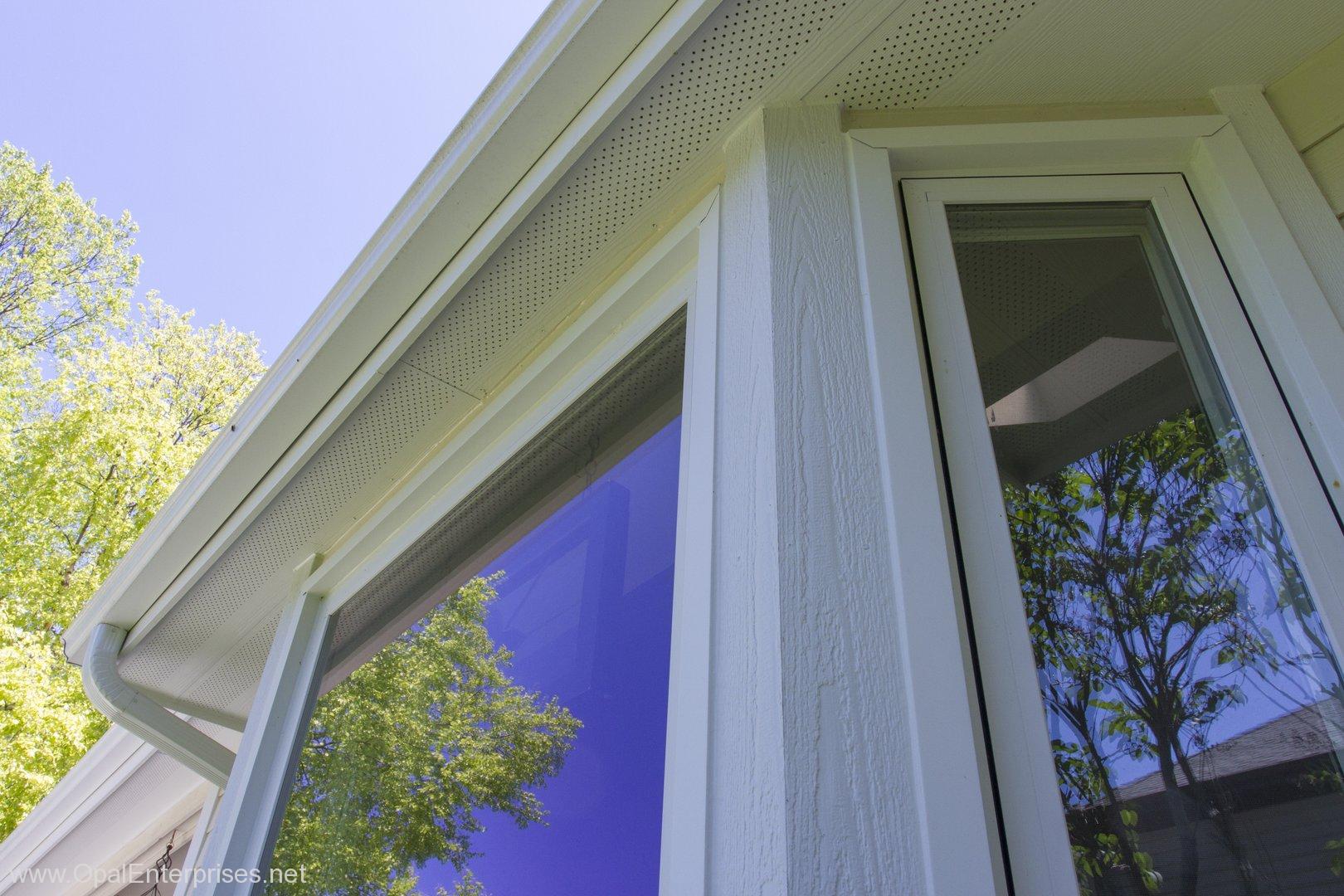 Close up of Andersen Windows reflecting blue skies