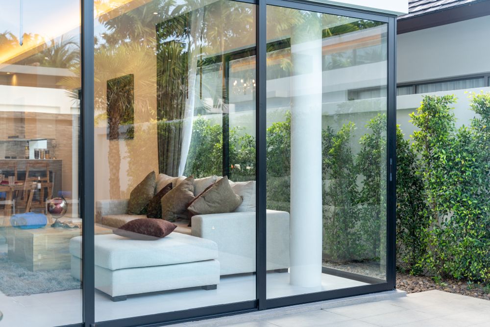 Living room sliding door leading to a backyard