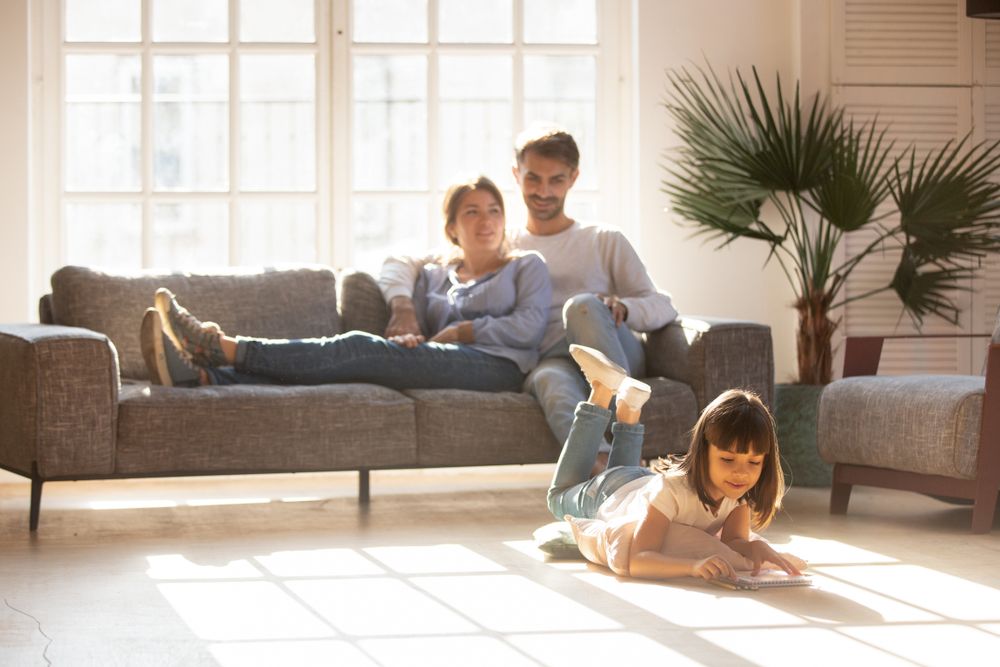 Family enjoying natural light from a newly installed picture window