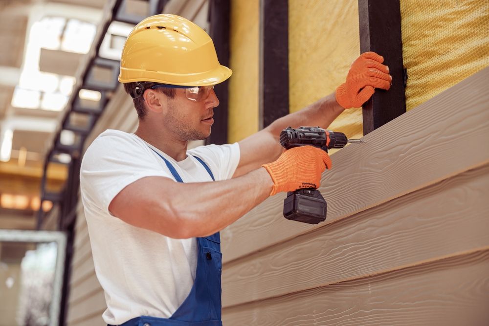 Siding installer working on a home exterior
