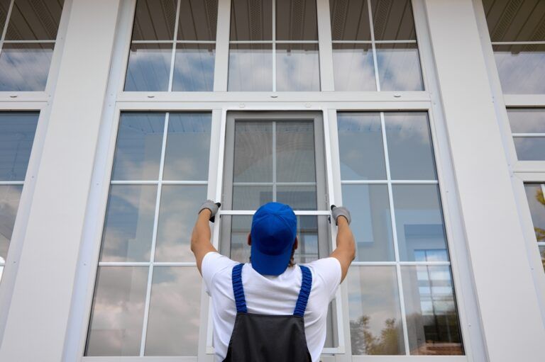 Technician replacing windows on a home